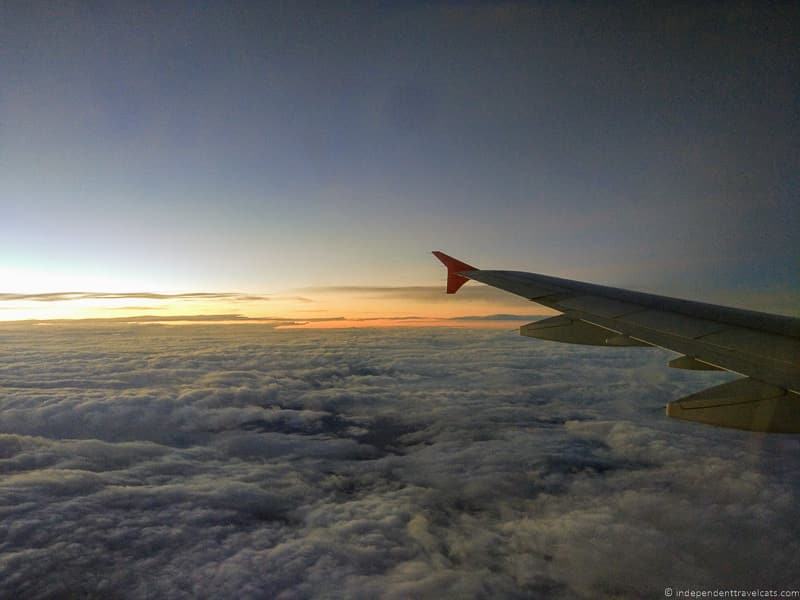 plane flying clouds carbon offset carbon neutral business travel blog