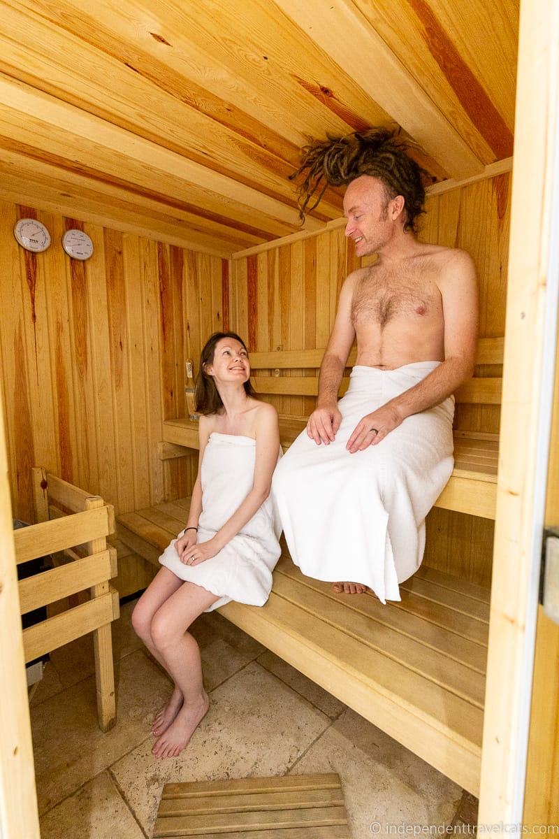 couple in sauna review of Plum Guide vacation rental booking website Somerset holiday homes