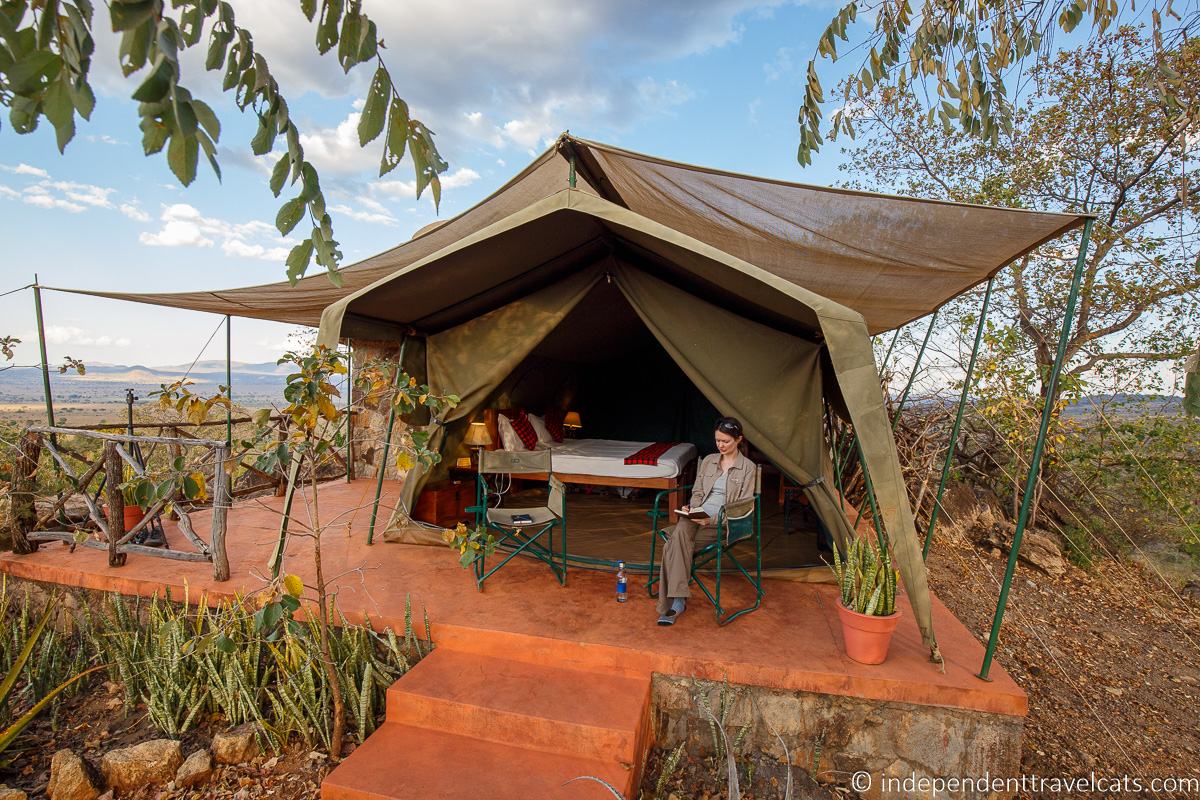 woman writing in travel journal during safari best travel journals for traveling